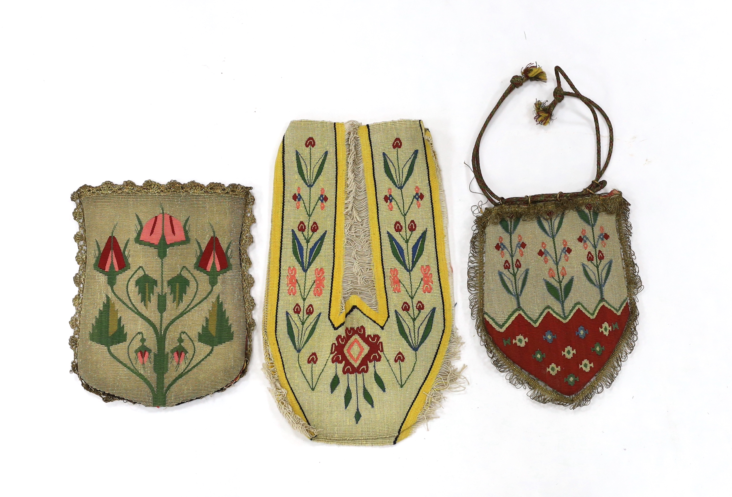 A pair of early 20th century uncut metallic floral tapestry slipper fronts, and two similar unused ladies draw string evening bags with gold braided edges
